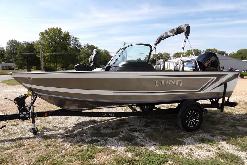 Slide: The Image of 2026 Lund 1875 Impact XS Sport boat on trailer, parked outdoors. - 6