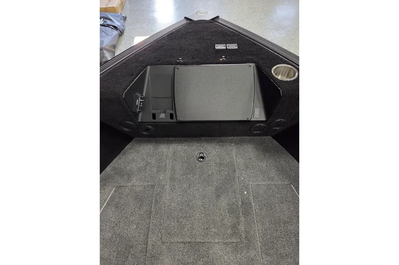 Slide: The Image of 2026 Alumacraft Competitor 185X Tiller boat interior with storage compartment and cup holder. - 4