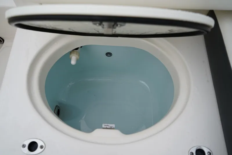 Slide: The Image of 2023 Robalo R222 Explorer livewell with open lid, showcasing interior design. - 11