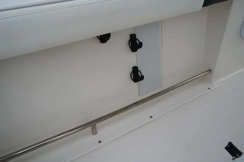 Slide: The Image of Interior view of 2023 Robalo R222 Explorer boat, featuring rod holders and stainless steel railing. - 12