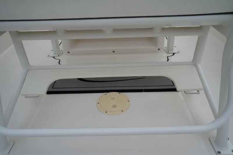 Slide: The Image of 2023 Robalo R222 Explorer boat interior detail, featuring storage and seating area. - 14