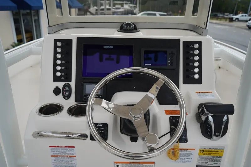Slide: The Image of 2023 Robalo R222 Explorer helm with steering wheel, controls, and navigation displays. - 17