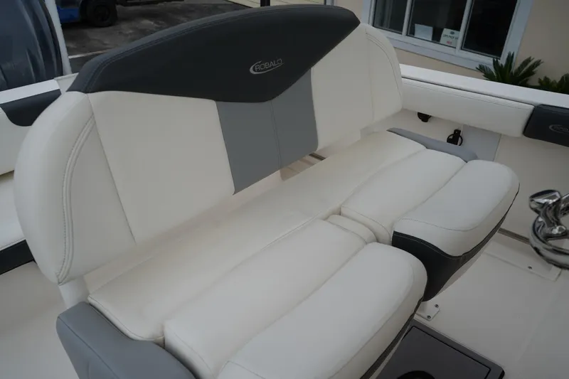 Slide: The Image of 2023 Robalo R222 Explorer boat seating with white and gray upholstery. - 18