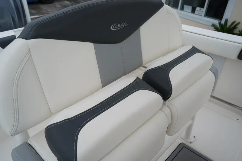 Slide: The Image of 2023 Robalo R222 Explorer boat seating, featuring sleek white and gray upholstery. - 19