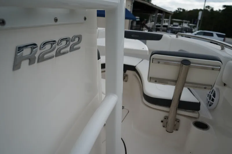 Slide: The Image of 2023 Robalo R222 Explorer boat interior with seating and R222 emblem. - 21