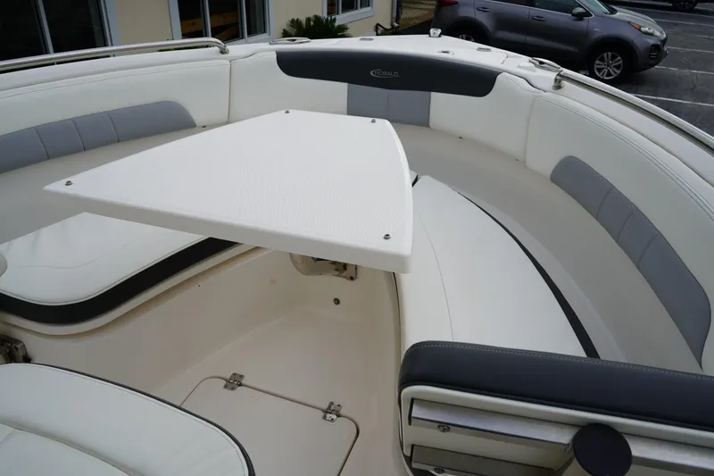 Slide: The Image of 2023 Robalo R222 Explorer boat interior with seating and table setup. - 22