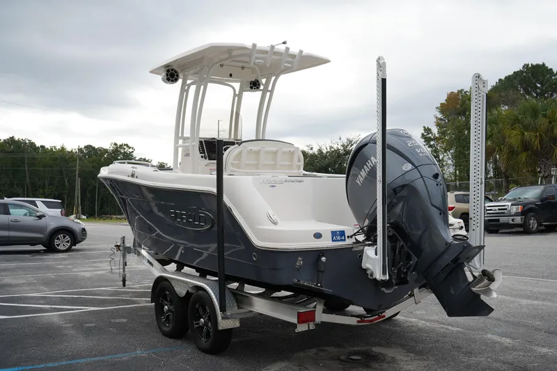 Slide: The Image of 2023 Robalo R222 Explorer boat on trailer with Yamaha outboard motor in parking lot. - 3