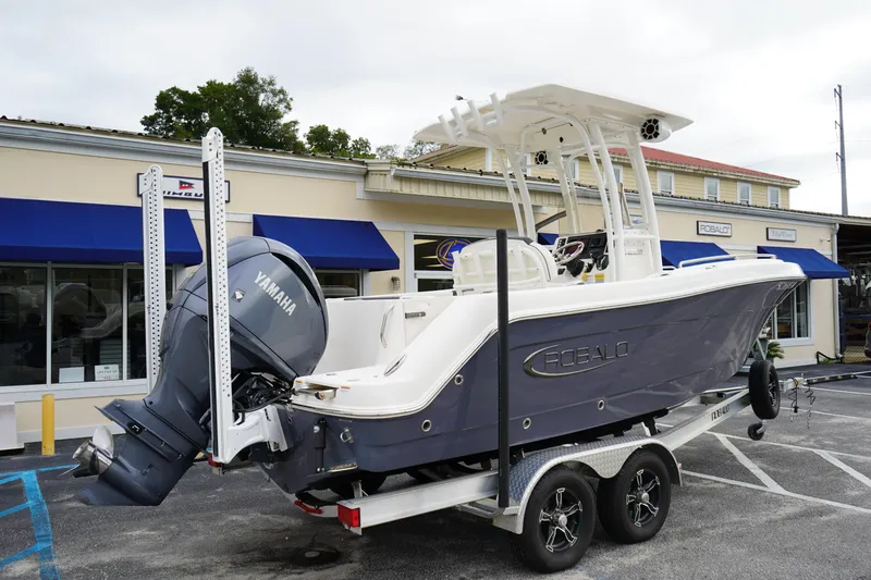 Slide: The Image of 2023 Robalo R222 Explorer boat on trailer with Yamaha engine, parked outside dealership. - 4