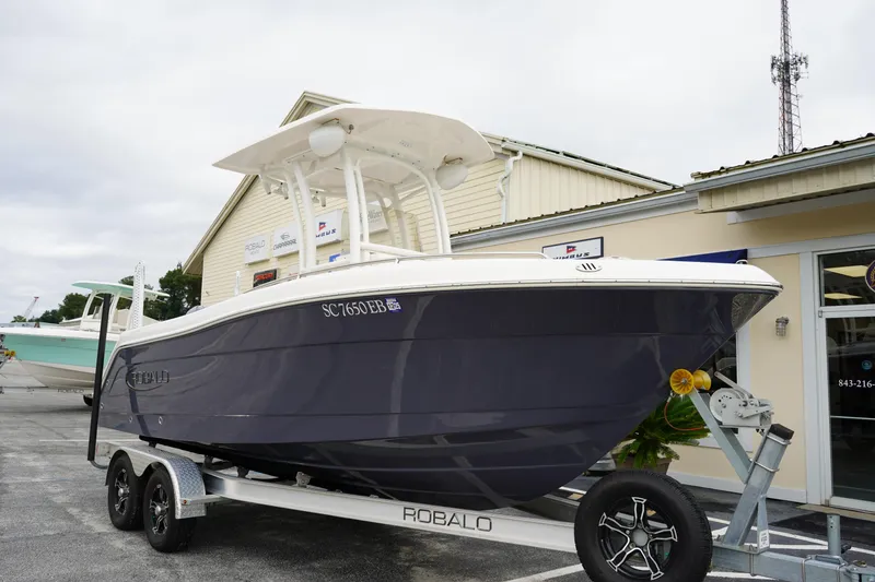 Slide: The Image of 2023 Robalo R222 Explorer boat on trailer, parked outside a building. - 5