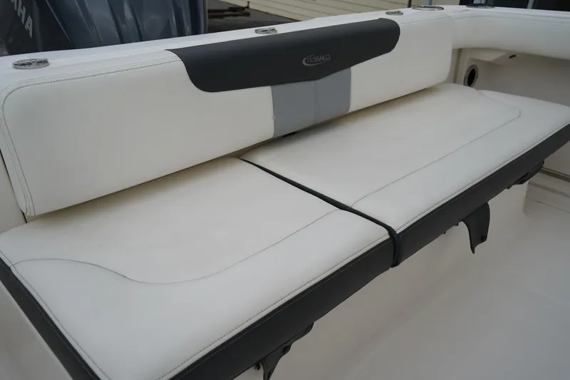 Slide: The Image of 2023 Robalo R222 Explorer boat seat with white and gray upholstery. - 8