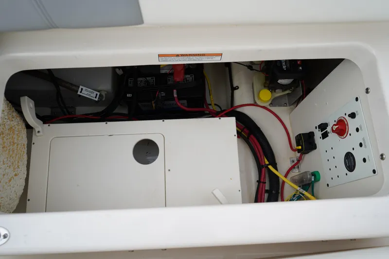 Slide: The Image of 2023 Robalo R222 Explorer boat electrical compartment with wiring and control panel. - 9