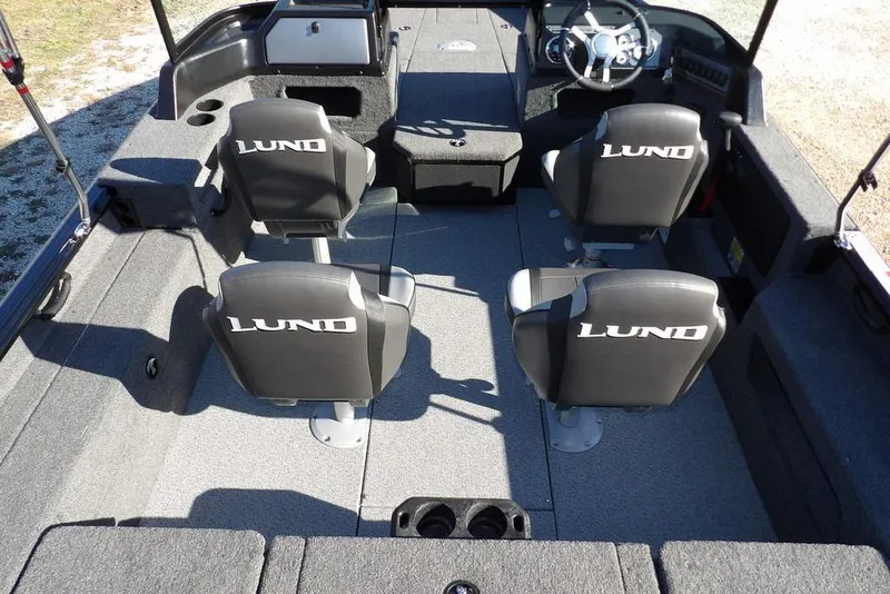 Slide: The Image of 2026 Lund 1875 Impact XS Sport boat interior with four branded seats and steering console. - 16