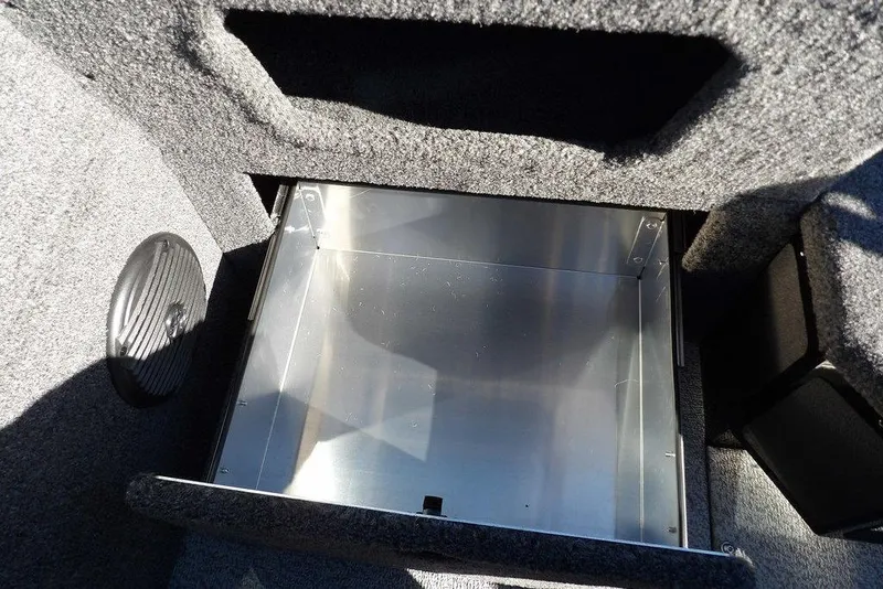 Slide: The Image of Storage compartment in 2026 Lund 1875 Impact XS Sport boat, featuring carpeted interior. - 20