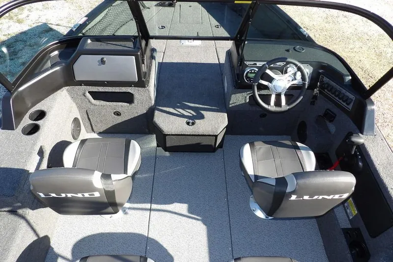 Slide: The Image of 2026 Lund 1875 Impact XS Sport boat interior with dual seats and steering console. - 25