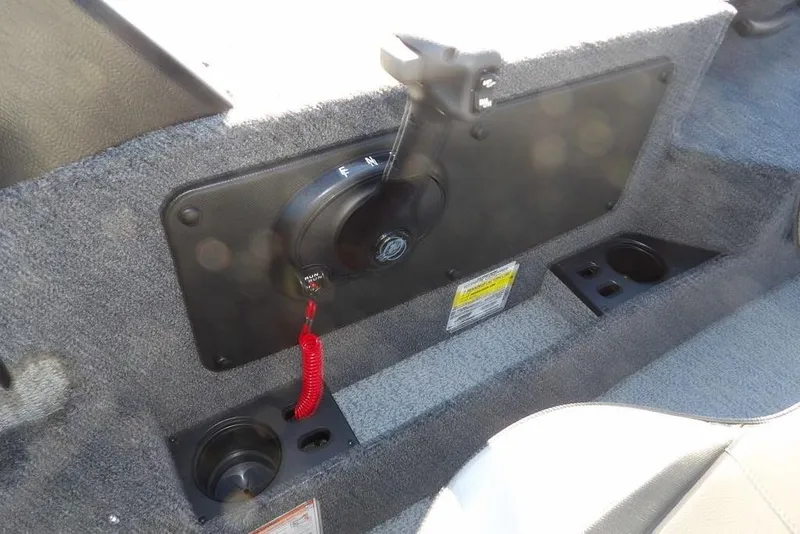 Slide: The Image of Interior of 2026 Lund 1875 Impact XS Sport boat with control panel and cup holders. - 28