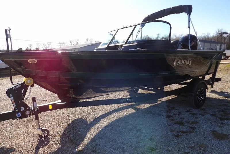 Slide: The Image of 2026 Lund 1875 Impact XS Sport boat on trailer, parked outdoors in sunlight. - 3