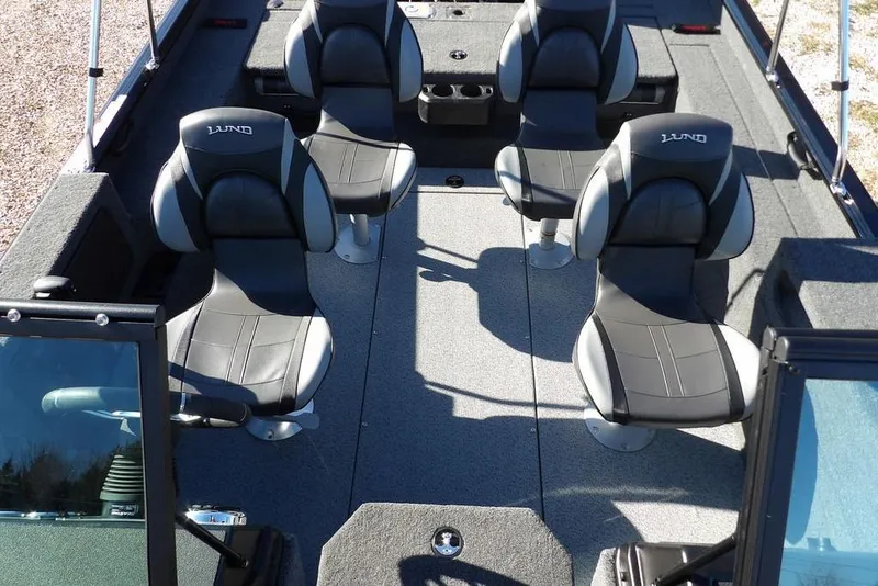 Slide: The Image of 2026 Lund 1875 Impact XS Sport boat interior with four black and gray seats. - 30