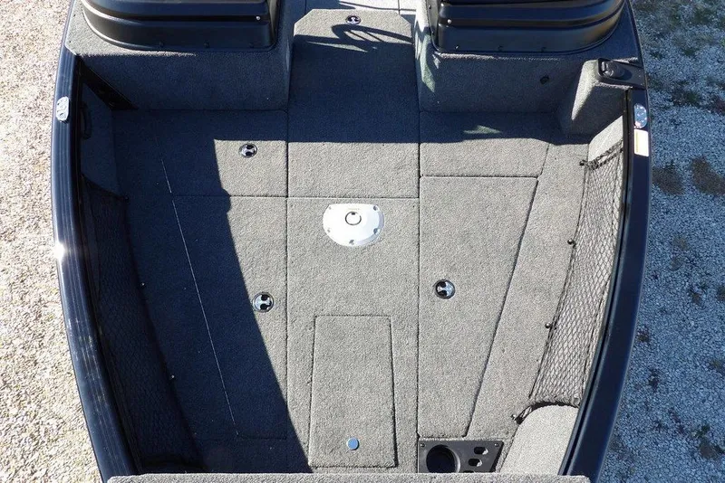 Slide: The Image of 2026 Lund 1875 Impact XS Sport boat interior with carpeted deck and storage compartments. - 33