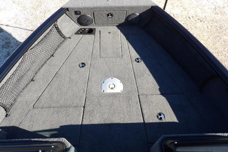 Slide: The Image of 2026 Lund 1875 Impact XS Sport boat interior with carpeted deck and storage compartments. - 36