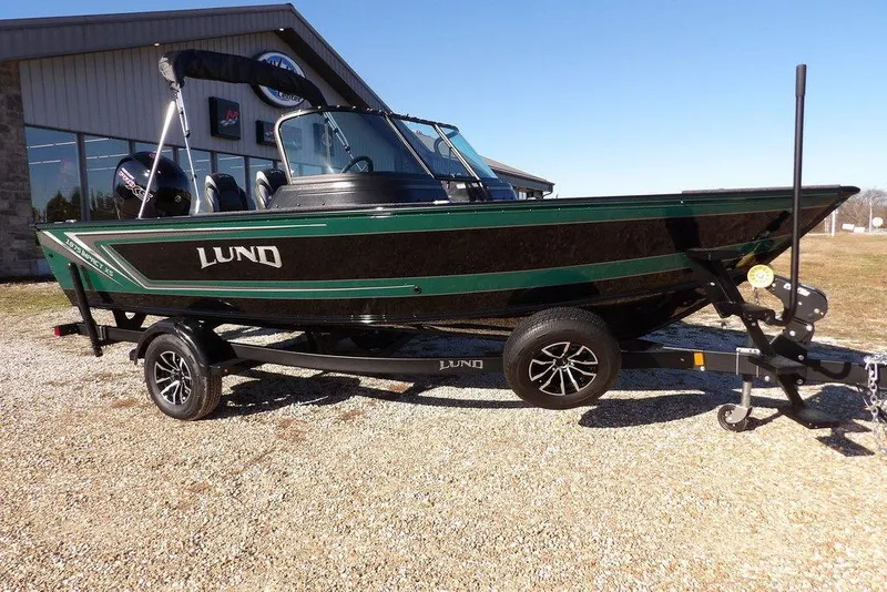 Slide: The Image of 2026 Lund 1875 Impact XS Sport boat on trailer, parked outdoors. - 4