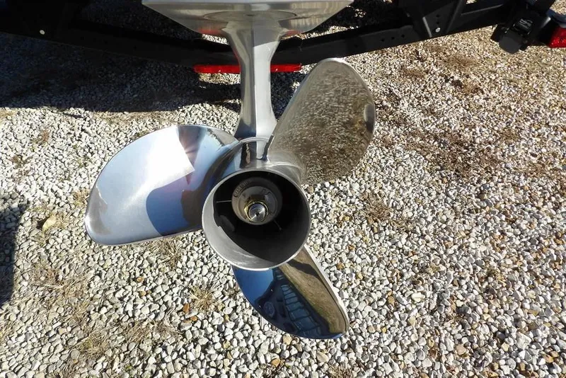 Slide: The Image of 2026 Lund 1875 Impact XS Sport boat propeller on gravel surface. - 41