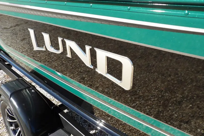 Slide: The Image of 2026 Lund 1875 Impact XS Sport boat with sleek green and black design. - 43