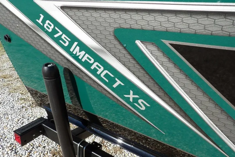 Slide: The Image of 2026 Lund 1875 Impact XS Sport boat with sleek green and gray design. - 45