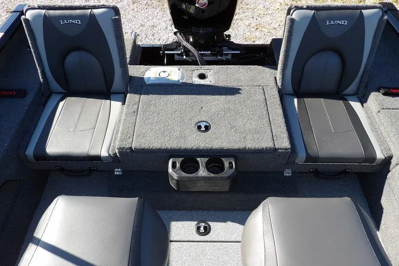 Slide: The Image of 2026 Lund 1875 Impact XS Sport boat interior with gray seating and storage compartments. - 9