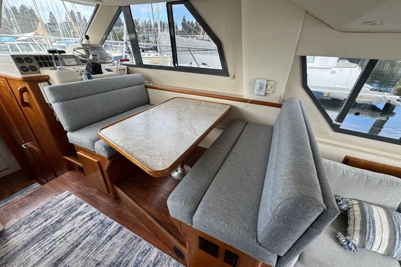Slide: The Image of Interior of 1996 Carver 370 Voyager with gray seating and wooden table. - 11