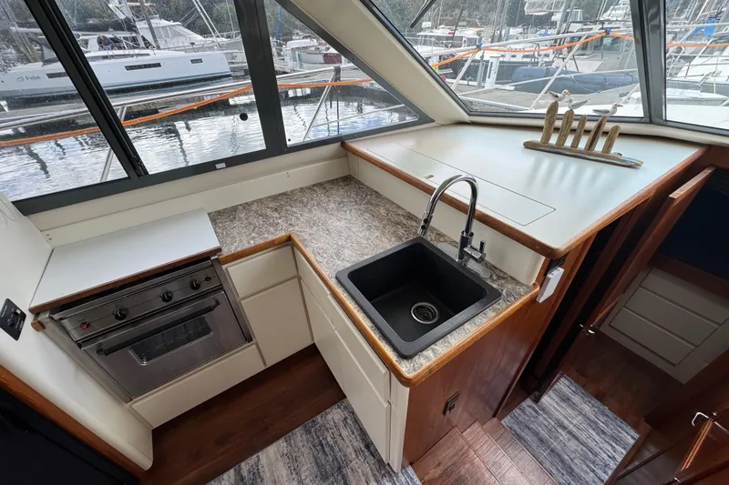 Slide: The Image of Interior of 1996 Carver 370 Voyager yacht kitchen with sink and stove. - 13