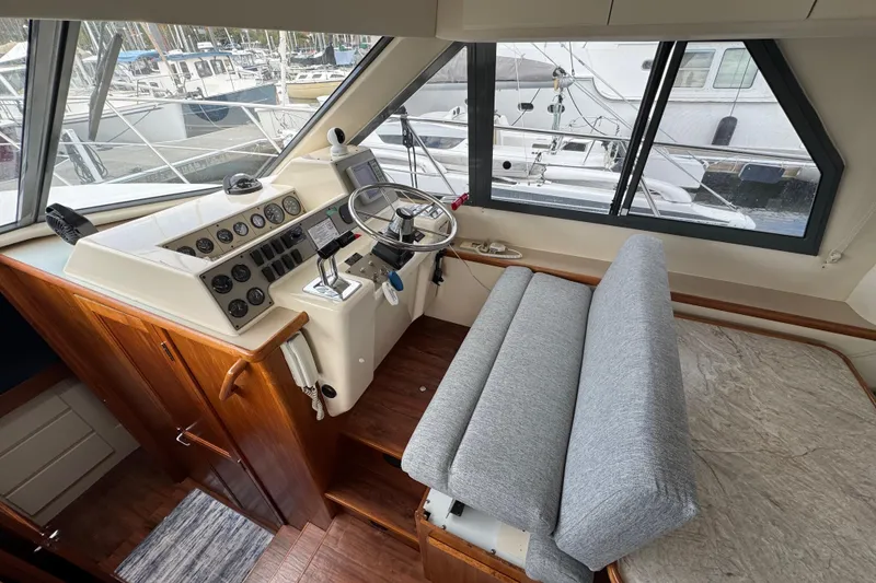 Slide: The Image of Interior helm of 1996 Carver 370 Voyager yacht with steering wheel and control panel. - 16