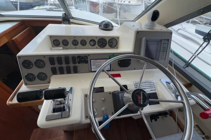 Slide: The Image of Helm of 1996 Carver 370 Voyager with steering wheel, gauges, and controls. - 17
