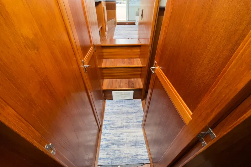 Slide: The Image of Interior of 1996 Carver 370 Voyager yacht with wooden finish and carpeted floor. - 19