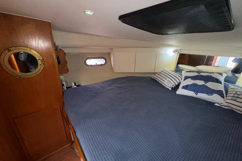 Slide: The Image of Cozy cabin interior of 1996 Carver 370 Voyager with nautical-themed bedding. - 24