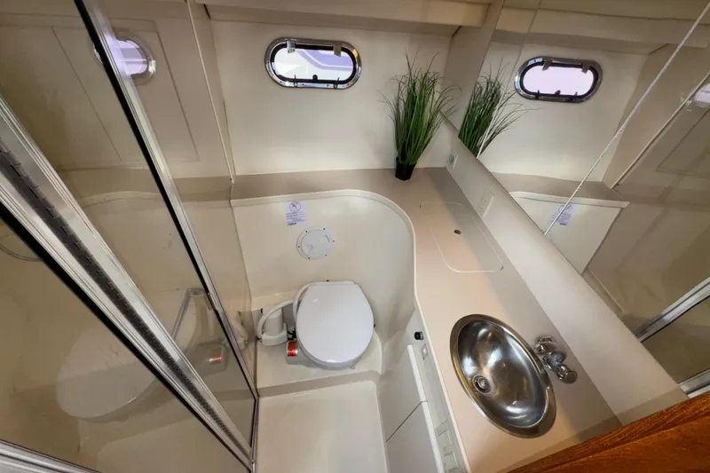 Slide: The Image of Bathroom interior of 1996 Carver 370 Voyager yacht with sink, toilet, and shower. - 26