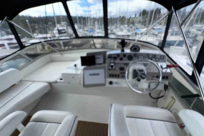 Slide: The Image of Interior view of a 1996 Carver 370 Voyager yacht cockpit with steering wheel and controls. - 32