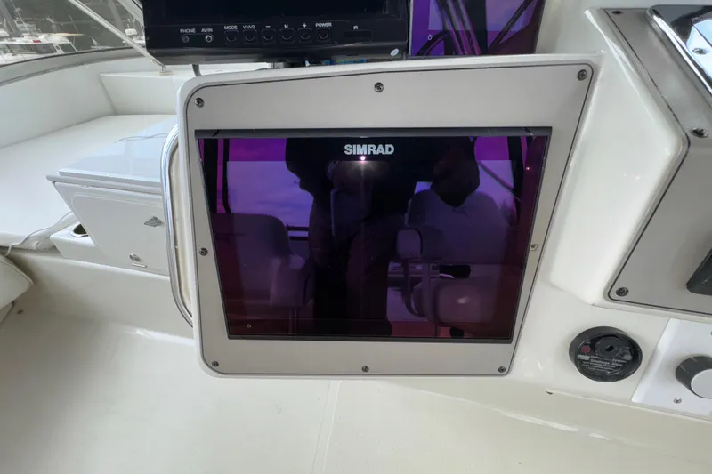 Slide: The Image of Simrad display on 1996 Carver 370 Voyager yacht dashboard, featuring navigation controls. - 35