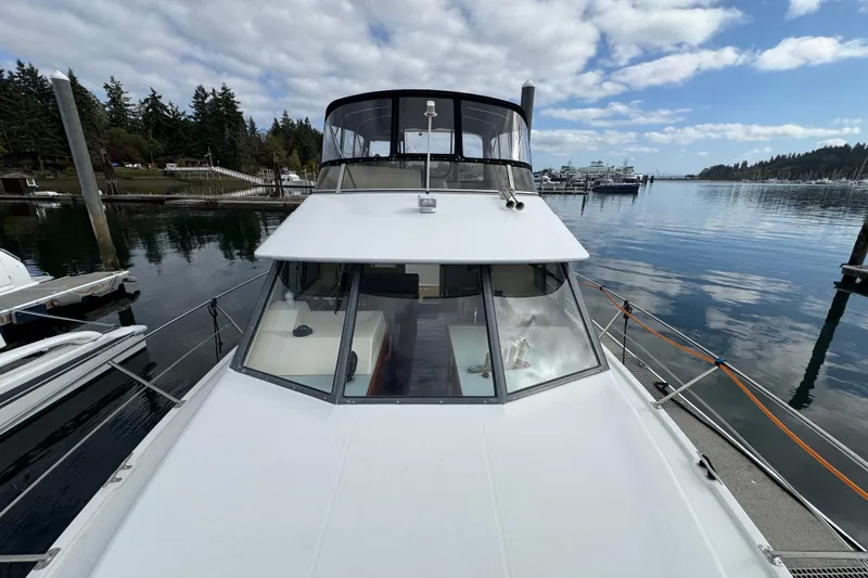 Slide: The Image of 1996 Carver 370 Voyager yacht docked in a serene marina setting. - 40