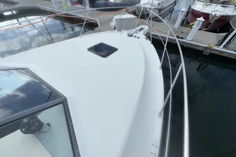 Slide: The Image of 1996 Carver 370 Voyager yacht docked at marina, showcasing sleek deck design. - 42