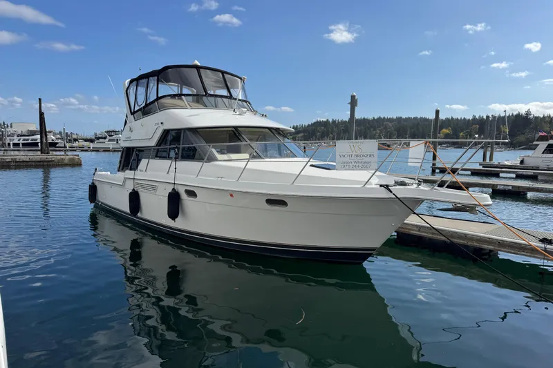 Slide: The Image of 1996 Carver 370 Voyager yacht docked at marina under clear blue sky. - 44