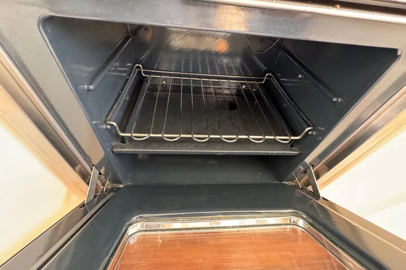 Slide: The Image of Open oven with metal rack inside, viewed from above. - 48