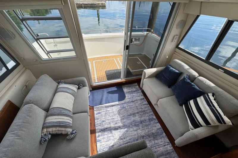 Slide: The Image of Interior of 1996 Carver 370 Voyager yacht with cozy seating and water view. - 5