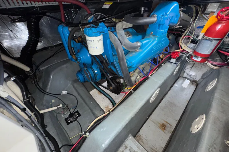 Slide: The Image of Engine compartment of a 1996 Carver 370 Voyager with visible blue engine and fire extinguisher. - 54