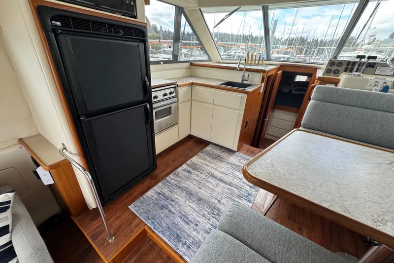 Slide: The Image of Interior of 1996 Carver 370 Voyager yacht with kitchen and dining area. - 7
