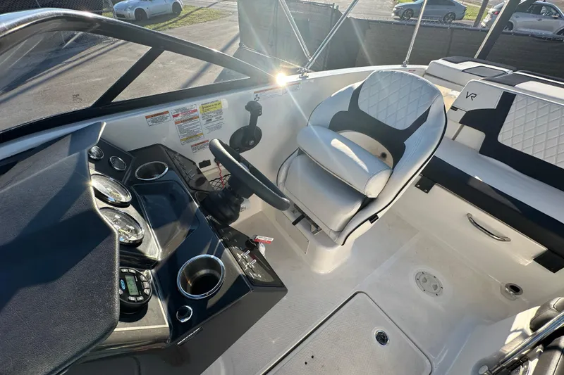 Slide: The Image of 2022 Bayliner VR5 Bowrider OB interior with white and black seating, speaker, and handle. - 68