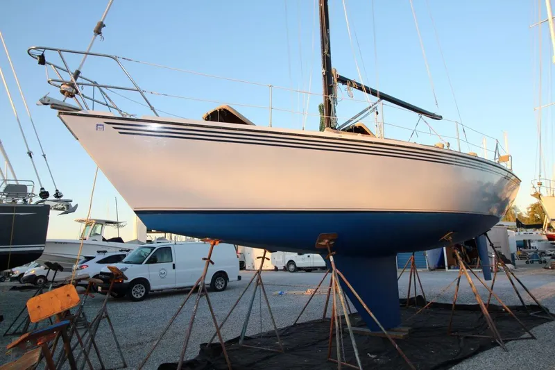 The Image of 1981 Ericson 36 sailboat on stands in a boatyard, side view. - 1