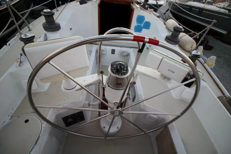 Slide: The Image of Cockpit of 1981 Ericson 36 sailboat with steering wheel and navigation instruments. - 14