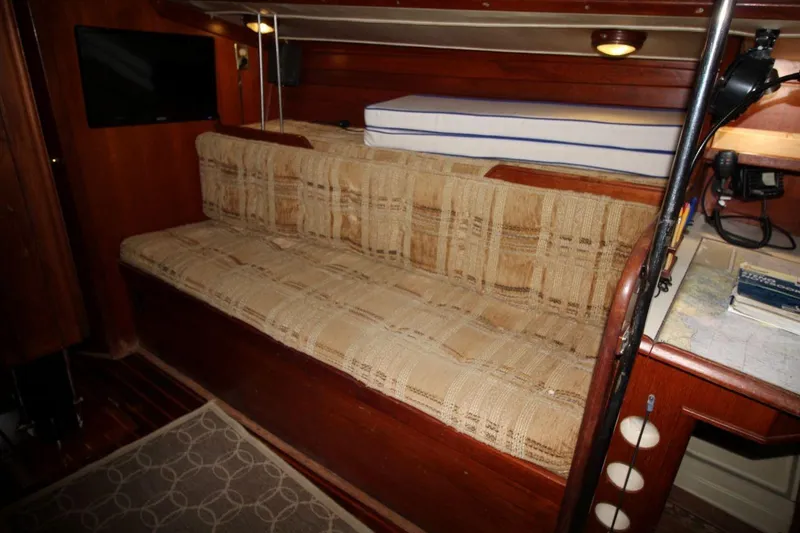 Slide: The Image of Interior of 1981 Ericson 36 sailboat with plaid sofa and navigation area. - 23