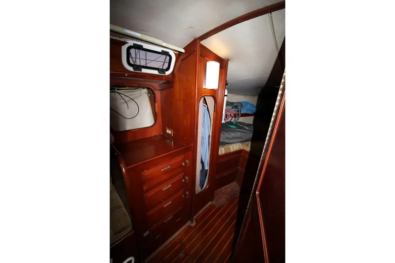 Slide: The Image of Interior of 1981 Ericson 36 sailboat with wooden cabinetry and cozy sleeping area. - 25