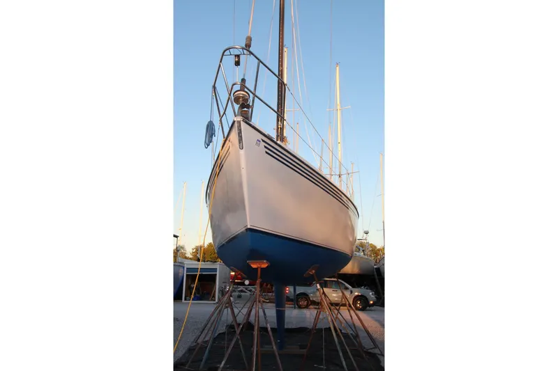 Slide: The Image of 1981 Ericson 36 sailboat on stands, blue hull, marina setting. - 4